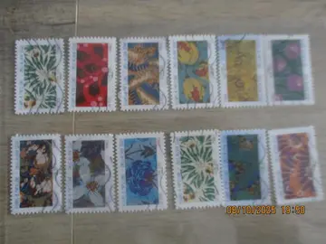 12 timbres oblitérés "Fleurs et Papillons"